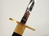 a gold and black sword with a black handle