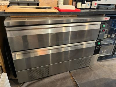 stainless steel ovens are stacked on top of each other in a kitchen
