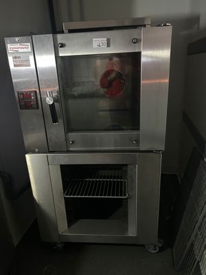 a silver oven that is sitting in the middle of a room