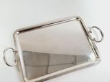 a silver tray with a mirror on it on a table