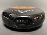 a close up of a small black object on a table