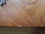 a close up of a piece of wood with a metal handle