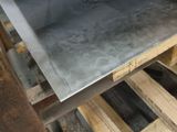 a pizza oven sitting on top of a wooden pallet