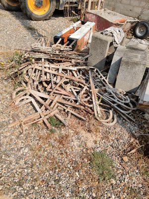 a large pile of wood sitting on the ground next to a construction truck