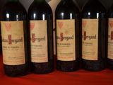 four bottles of wine are lined up on a table