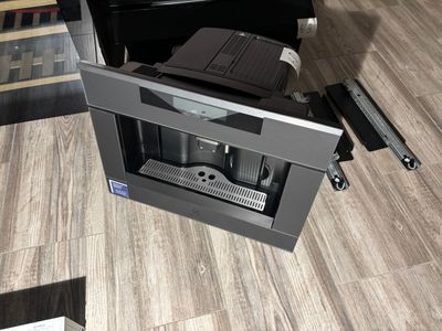 a coffee machine sitting on the floor in a living room