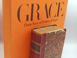 an orange book sitting next to a brown book on top of a white table