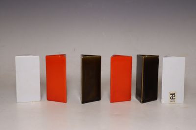 four different colors of books lined up in a row on a white surface