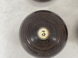 three brown vases with numbers on them sitting on a table