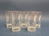 three glasses are lined up on a blue surface with a black background