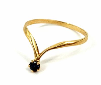 a close up of a gold ring with a black diamond