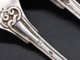 two spoons that are sitting next to each other