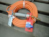 an orange hose with a hose attached to it sitting on a wooden bench