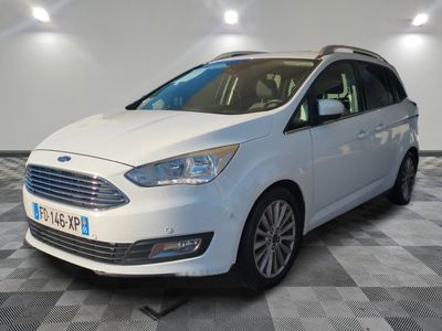 the white ford grand tourer is parked on a checkered floor