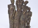 statue of a group of people standing on a rock with a white background