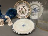 many plates and vases that are on the table