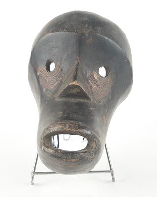 a black mask on a stand on a white background