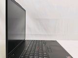 the back of a laptop computer sitting on top of a white table