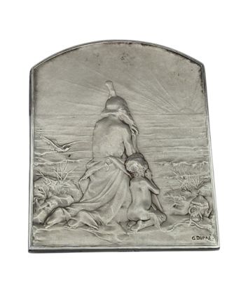 an antique silver plaque depicting a woman and a dog