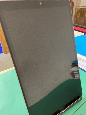 a laptop computer sitting on top of a green desk