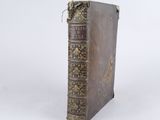 an old book sitting on top of a white table
