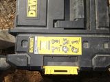 a black and yellow tool box sitting on the ground next to a pair of shoes