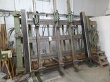 a machine that is sitting in a room with many pieces of wood