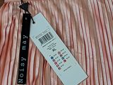 a pink pleated dress with a tag on it