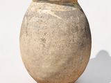 a small vase that is sitting on a white surface