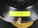 a close up of a fireman ' s helmet with a yellow tag on it