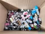 a cardboard box filled with various types of cosmetics