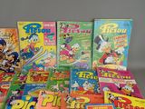 a lot of cartoon books that are on the table