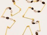 a set of five gold plated necklaces with black, white and grey stones