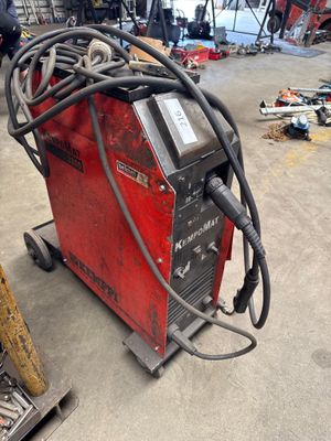 an image of a welding machine in a garage with other tools