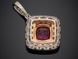 a silver and gold pendant with a purple stone in the center