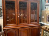 a wooden cabinet with a glass door in a room