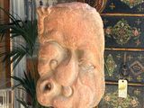 a statue of a man ' s face on display in a store