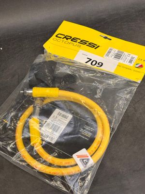 a close up of a yellow hose on a black surface