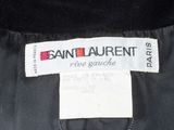 the label on the back of a black jacket is clearly visible