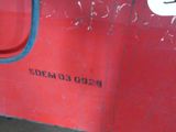 a red boat with a blue rope on the side