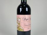 the bottle of red wine is sitting on the table