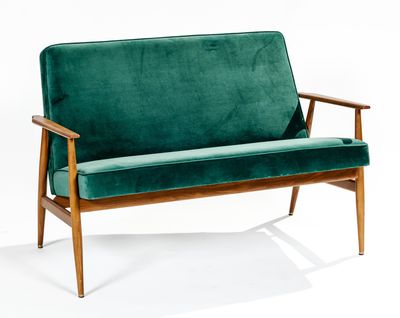 an image of a green couch sitting on top of a white floor