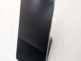 an image of a cell phone on a stand on a white surface