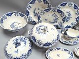 many pieces of blue and white china on the table