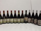 several bottles of wine are lined up on a table