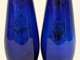 two blue vases sitting next to each other on a table