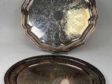 a silver plate with a mirror on top of it on a table