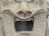 a stone mask with a large mouth and teeth