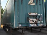 two semi trucks parked next to each other in a parking lot