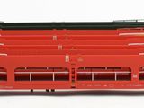 a red train on the tracks next to a black train car
